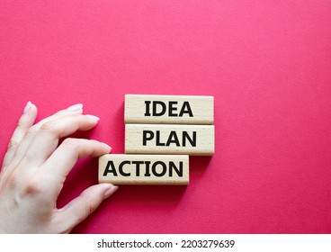 Idea Plan Action Symbol. Wooden Blocks With Words Idea Plan Action. Beautiful Red Background. Businessman Hand. Business And Idea Plan Action Concept. Copy Space.