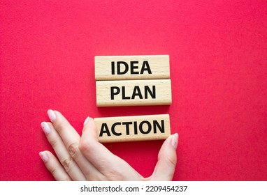 Idea Plan Action Symbol. Wooden Blocks With Words Idea Plan Action. Beautiful Red Background. Businessman Hand. Business And Idea Plan Action Concept. Copy Space.