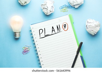 idea with plan b text writeen on notebook on blue background