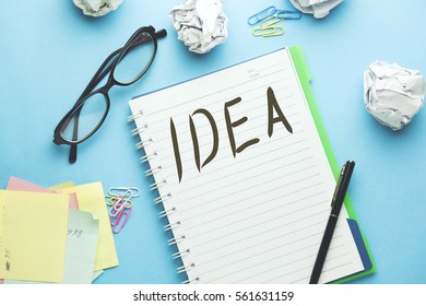 Idea text writeen on notebook with glasses