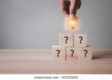 Idea wood block Concept. hand holding block Stacked together and then have Symbolic question Is to doubt the ignorance The wooden block above is a light bulb and is lit to show creativity, ingenuity. - Shutterstock ID 1922702543