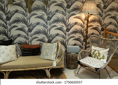 Ideal Home Show June 2019. Cropped Shot Of Couch With Pillows In Living Room With Green Wall.