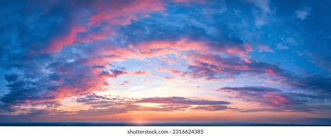 Ideal for Sky replacement project: Panoramic, colorful pink-orange-blue dramatic sky with clouds  illuminated by red sunset, aerial photography, far horizon without obstacles. - Shutterstock ID 2316624385