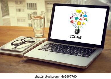 IDEAS Computing Computer  Laptop with screen on table Silhouette and filter sun