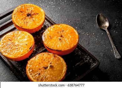 Ideas for a healthy dietary vegan breakfast. Paleo diet. Grilled oranges grapefruits. In the grill pan on a black stone table. Copy space  - Powered by Shutterstock