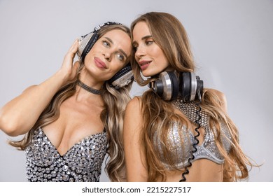 Identical Twin Female DJs Dancing In Silver Costumes