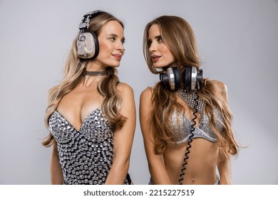 Identical Twin Female DJs Dancing In Silver Costumes