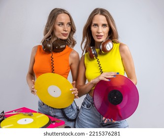 Identical Twin Female DJs Dancing Behind Record Turntables