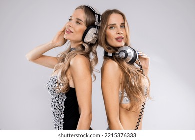 Identical Twin Female DJs Dancing In Silver Costumes