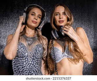 Identical Twin Female DJs Dancing In Silver Costumes