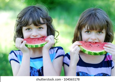 Identical Twin Girls Eating Water Melon