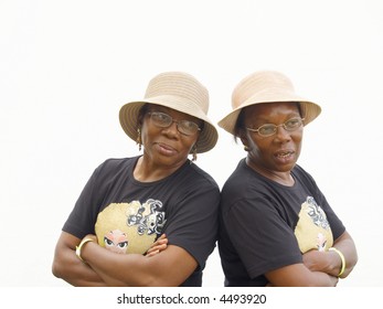 Identical Twin Sisters In Hats And Black T-shirts