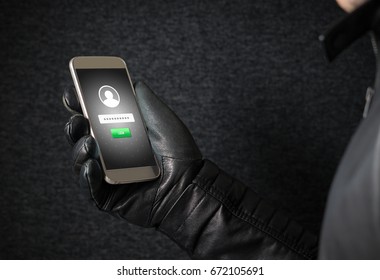 Identity theft and cyber security concept. Mobile hacker and criminal login to persons online social media account or personal information and data with smartphone. Thief with black leather gloves. - Powered by Shutterstock