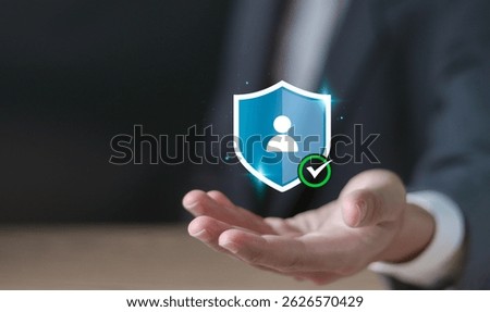 Identity verification concept. User authentication and access management. Businessman holding shield protect with verify identity icon on virtual screen.