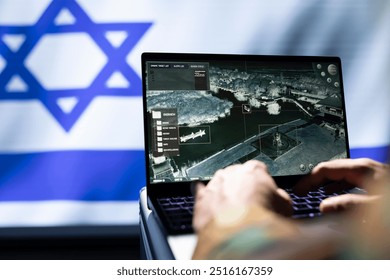 IDF army operative engaged in surveillance mission using notebook, looking at aerial map of conflict zone. Intelligence corps officer isolated over Israel flag monitoring zone of interest - Powered by Shutterstock