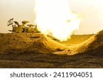 IDF M109 artillery cannon fires 155mm shells at the Gaza Strip and creates a strong burst of fire, in order to attack Hamas targets, assisted the army force in the field as part of Hamas Israel war23