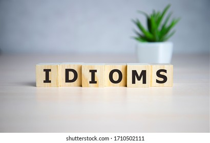 Idioms word concept on cubes, jargon concept.