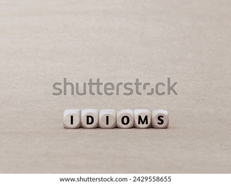 IDIOMS word on wooden cube.