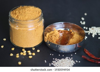 Idli podi or milagai podi is a dry vegan condiment served with idlis or dosa. Basically idli milagai podi is a dry powder made with lentils and red chilies. Shot on black background