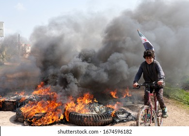 IDLIB, SYRIA, Syrians protest and burn tires in an attempt to block traffic on the M4 highway, before incoming joint Turkish and Russian military patrols on March 15, 2020.