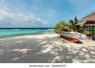Idyllic beach scene with a traditional boat  in Maldives, North Male Atoll