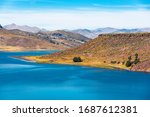 The idyllic blue colors of the high altitude Umayo Lake near Puno and the Titicaca Lake, Andes mountains and altiplano, Peru.