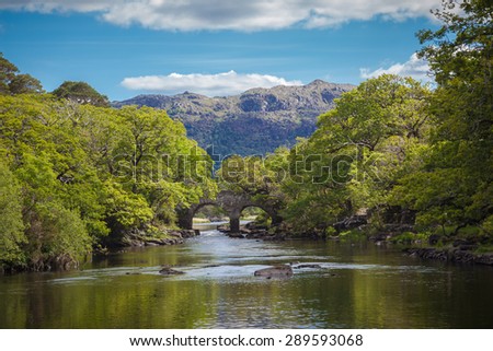 Idyllic Irish Setting With An Old Bridge Over A Beautiful River