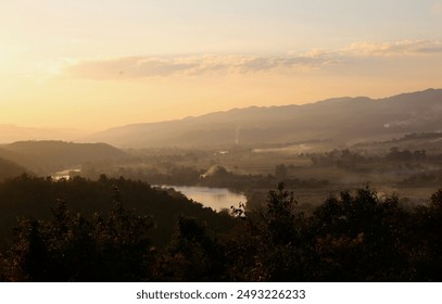 Idyllic landscape at dusk with rolling hills and a lake, warm sunset sky - Powered by Shutterstock