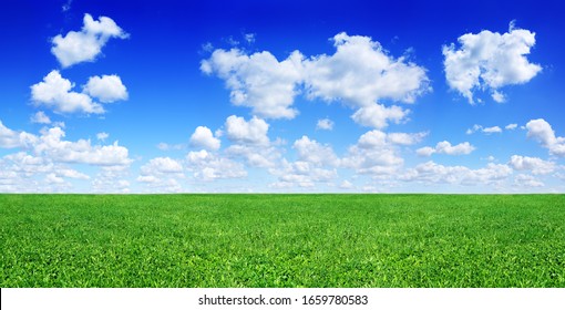 Idyllic Landscape, Green Fields, Blue Sky And White Clouds In The Background