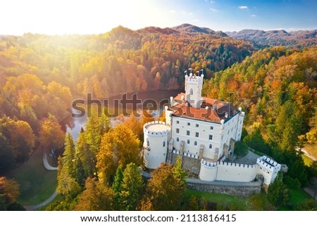 Idyllic old town and lake of Trakoscan in Zagorje region aerial view in autumn colors and sun haze, northern Croatia