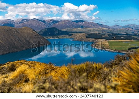 idyllic panorama of lake coleridge, rakaia gorge and alp moutains seen from the top of peak hill in canterbury, new zealand south island