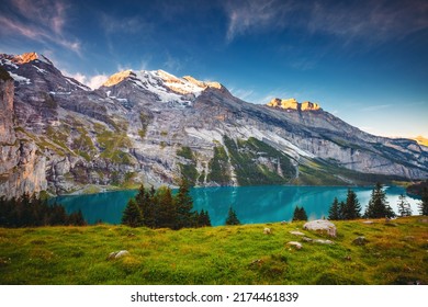 Idyllic panoramic view of the lake Oeschinensee in day. Location Swiss alps, Switzerland, Kandersteg district, Europe. Picturesque photo wallpaper. Image of exotic place. Discover the beauty of earth. - Shutterstock ID 2174461839