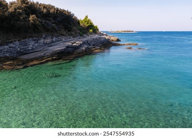 Idyllic paradise lagoon in Cape Kamenjak National Park near Premantura, Istria, Croatia. Turquoise water of Adriatic Mediterranean Sea in summer. Distant view of white lighthouse Porer. Seascape - Powered by Shutterstock