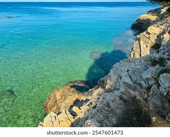 Idyllic paradise lagoon in Cape Kamenjak National Park near Premantura, Istria, Croatia. Turquoise water of Adriatic Mediterranean Sea in summer. Distant view of white lighthouse Porer. Seascape - Powered by Shutterstock