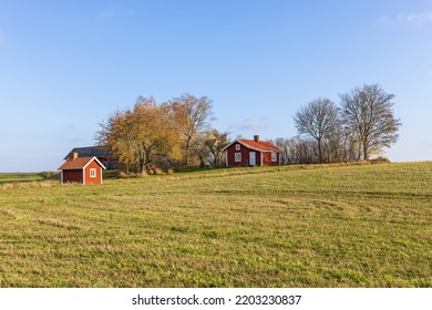 Idyllic Red Cottage On A Hill At Autumn