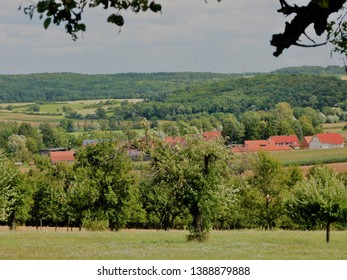 Idyllic South German Landscape With Fruit Tree Meadow A Small Village And Forest, 