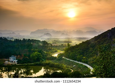 Idyllic sunset over Chinese rice fields and nature on Guangxi province