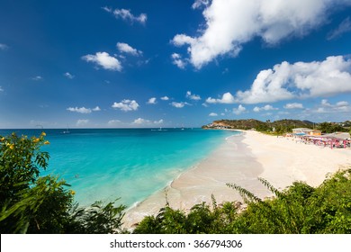 Idyllic tropical Darkwood beach at Antigua island in Caribbean with white sand, turquoise ocean water and blue sky