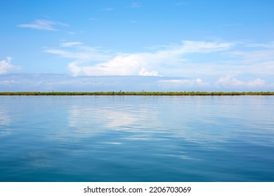 Idyllic View Of Blue Cloudy Sky Reflected On The Water