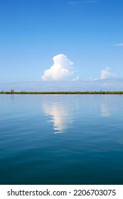 Idyllic View Of Blue Cloudy Sky Reflected On The Water