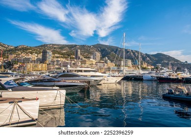 Idyllic view of the harbor (Port Hercule) of Monaco with luxury yachts and the skyline of Monaco in the background - also famous old  building 