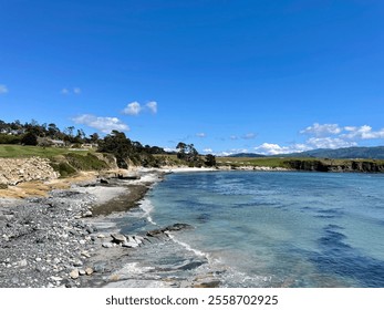 Idyllic view of Pebble Beach coastline with blue sky and rocky shore. - Powered by Shutterstock