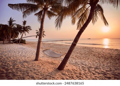 Idyllic wallpaper of a hammock on a tropical island among palm trees at sunset - Powered by Shutterstock