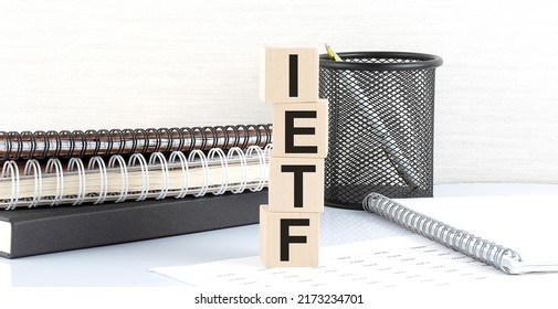 IETF Internet Engineering Task Force Text On Wooden Block With Notebooks On A White Background