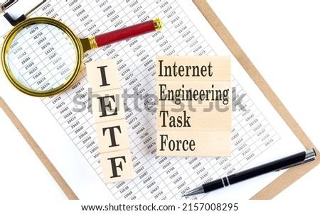 IETF Internet Engineering Task Force text on a wooden block on chart background