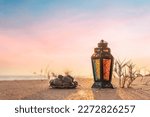 Iftar concept image lantern lamp with dates on the beach, sunset view from the beach and Ramadan Mubarak concept background