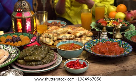 Iftar During Ramadan. Muslims break the fast with dates. When the sun goes down, family and friends typically gather around a table of lavish feasts