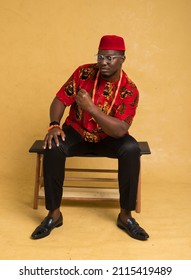 Igbo Traditionally Dressed Business Man Sitting Down and Calmly Celebrate
