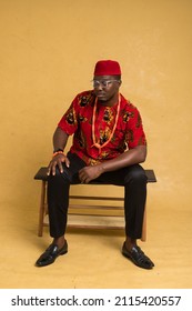 Igbo Traditionally Dressed Business Man Sitting Down and Looking Down