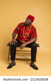 Igbo Traditionally Dressed Business Man Sitting Down and Posturing